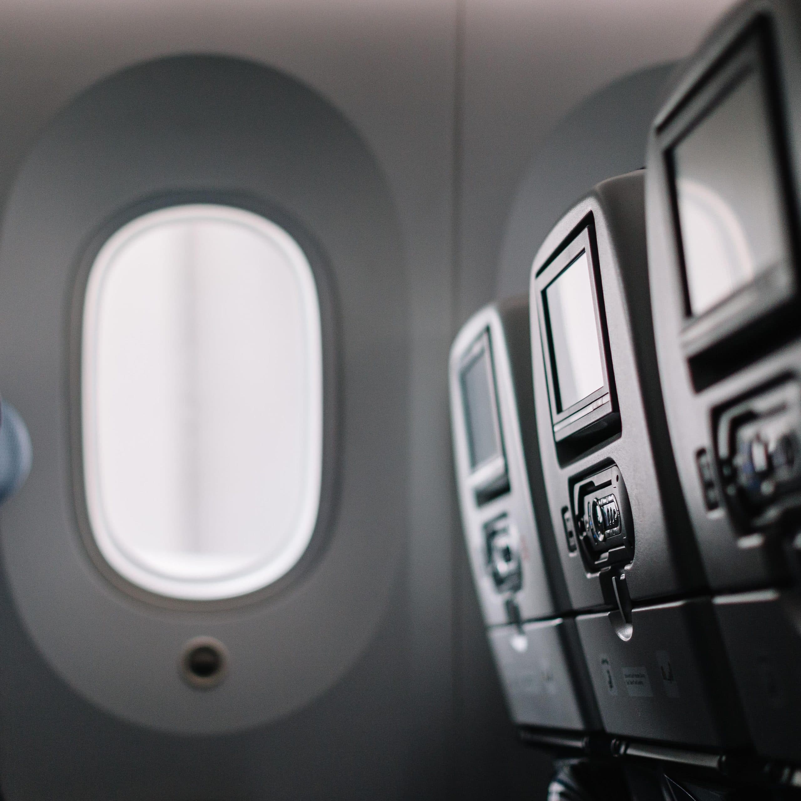 An airplane wing view from a window seat during a flight, representing a first-time flyer's journey