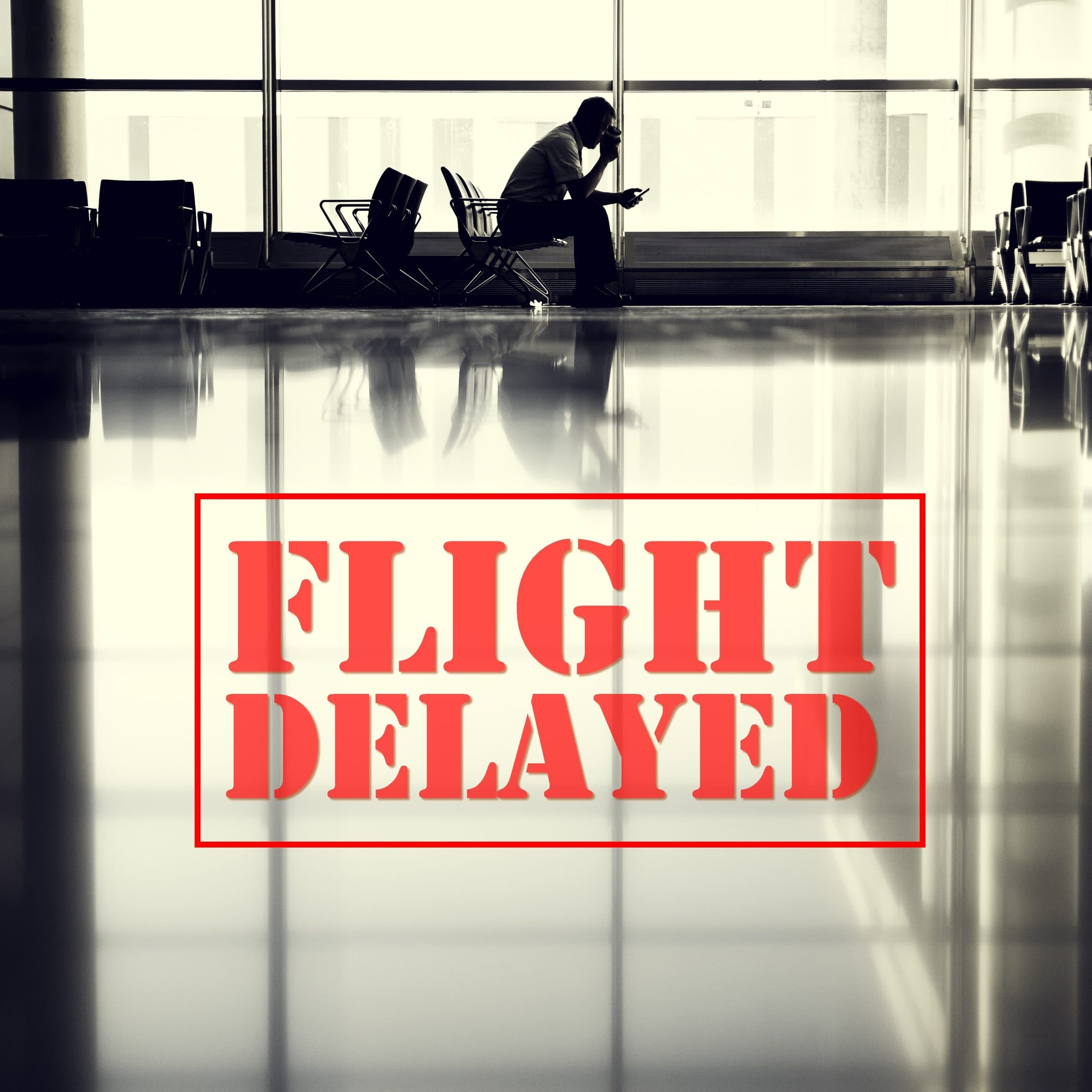 Departure board at an airport showing a delayed flight status