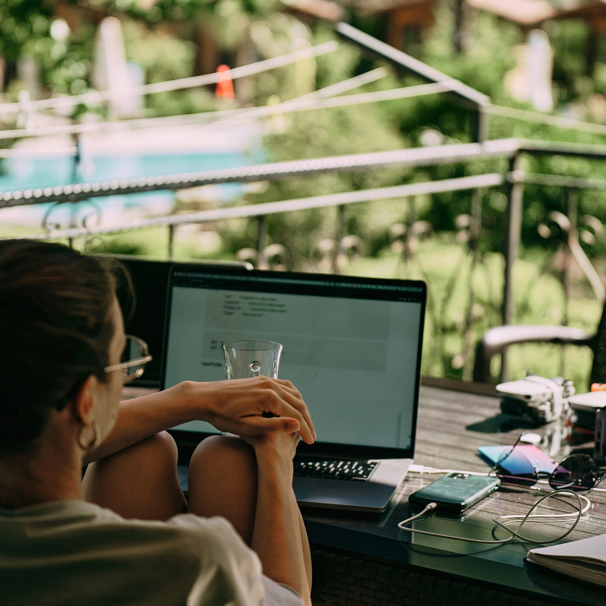 A laptop and coffee set up at a workspace, representing the remote-work lifestyle of a digital nomad